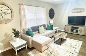 a living room with a couch and a tv at Peaceful Haven 2BR 1BA in Quiet Neighborhood in Nederland