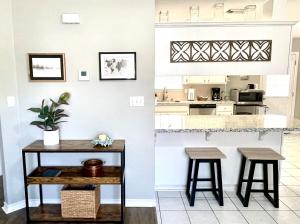 a kitchen with a table and two stools at Peaceful Haven 2BR 1BA in Quiet Neighborhood in Nederland