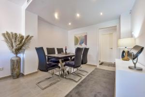 a dining room with a table and chairs at Flat 58 - City Center Moraira in Moraira