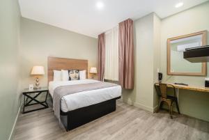 a hotel room with a bed and a desk at Urban Boutique Hotel- Little Italy, Downtown San Diego in San Diego