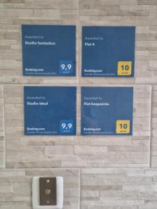 a wall with four blue signs on a brick wall at Studio fantástico in São Paulo