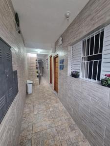 a hallway of a building with a tile floor at Studio fantástico in São Paulo