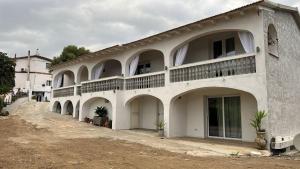 a large white building with arches and balconies at L 'alchitti in Budoni