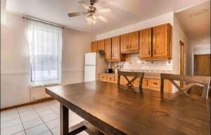 a kitchen with wooden cabinets and a wooden table at Full Unit METRO VERDUN Pet Friendly in Montréal