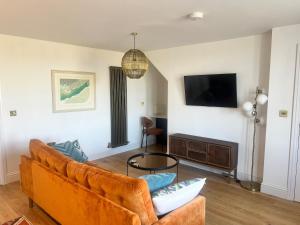 a living room with a couch and a tv at Valley View in Keynsham