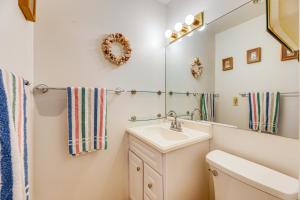 a bathroom with a sink and a mirror at 200 Feet to Beach Inviting Condo in Ocean City! in Ocean City +16 photos