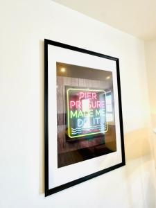 a framed picture of a sign on a wall at Central Bournemouth - 2-Bedroom - 4 Guests - Prime Spot in Bournemouth