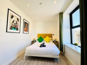 a bedroom with a white bed and a window at Central Bournemouth - 2-Bedroom - 4 Guests - Prime Spot in Bournemouth