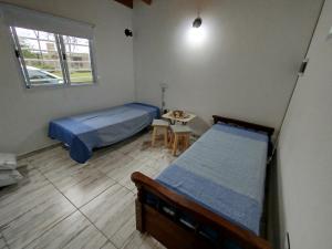 a bedroom with a bed and a table and a window at La Francisca in San Miguel del Monte +183 photos