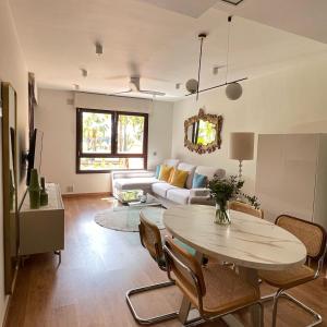 a living room with a table and a couch at La casa de Mateo Playa Granada in Motril +23 photos
