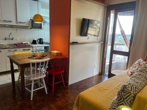 a small kitchen with a table and chairs in a room at Apartamento com vista para o Vale dos Vinhedos in Bento Gonçalves