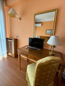 a room with a desk with a mirror and a chair at TatyHouse in Rome