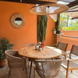 a dining room with a wooden table and chairs at La casa de Mateo Playa Granada in Motril