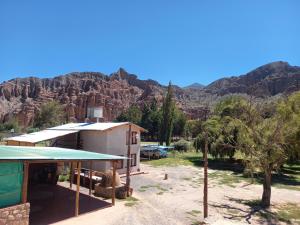 a building with a mountain in the background at Departamentos Complejo Turístico Cruz Mendoza in Tilcara +52 photos