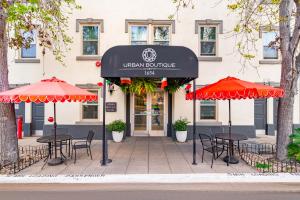 a cafe with tables and umbrellas in front of a building at Urban Boutique Hotel- Little Italy, Downtown San Diego in San Diego