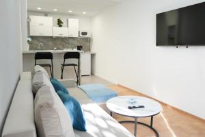 a living room with a couch and a table at Champagne Apartments in Portorož