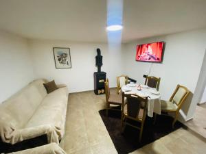 a living room with a couch and a table at Villa Sara - Apartments & Garden, Kratovo in Kratovo