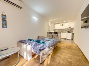 a living room with a couch and a kitchen at Champagne Apartments in Portorož