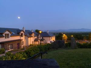 a group of houses on a hill at dusk at Beach House Inch in Inch