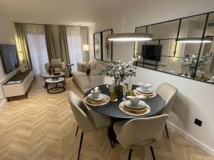 a living room with a table and chairs in a room at Exclusivo Apartamento en el centro de Murcia in Murcia