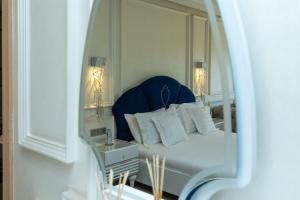 a bedroom with a bed with a blue headboard and a mirror at Villa Golf Marrakech in Marrakech +37 photos