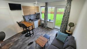 a living room with a couch and a table and a kitchen at B&B MiRo in Rouveen