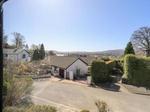 arial view of a house with a driveway at Striding Home in Ambleside