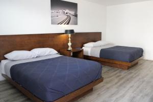 Postel nebo postele na pokoji v ubytování HOTEL MARIPINA