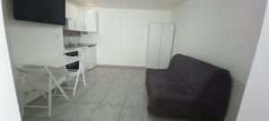 a kitchen with a table and a chair in a room at Studio centre ville de Gagny in Gagny