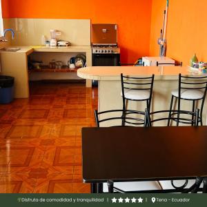 a kitchen with a table and chairs in a room at RinaKawsay - ViveViajando Apartamento amoblado en Tena in Tena +20 photos