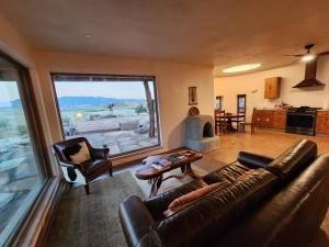 a living room with a couch and a large window at Sky Village in Cortez