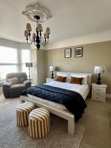 a bedroom with a large bed and a chandelier at Charming city home free parking in Portsmouth