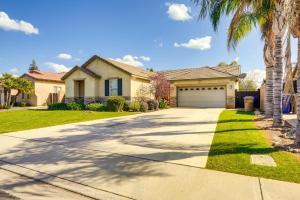 a house with a driveway and a garage at 8 Mi to Beach Park Bakersfield Gem with Yard! in Bakersfield