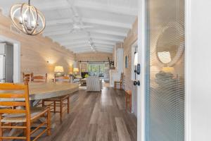 a dining room and living room with a table and chairs at Private Pool and Just a 3 Minute Walk to the Beach in Pawleys Island
