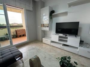 A television and/or entertainment centre at Arenal Golf Apartment