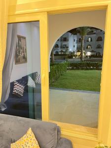 a sliding glass door with a view of a yard at COMFY ZONe in Sharm El Sheikh