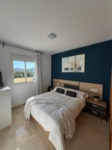 A bed or beds in a room at Arenal Golf Apartment