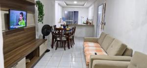 a living room with a couch and a table at Casa com piscina em Itamaracá in Itamaracá