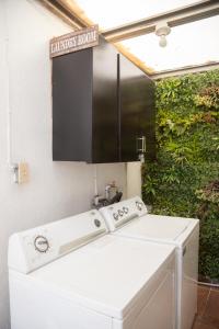 a bathroom with a white sink and a laundry room at Life Hospitality in Ensenada +63 photos