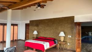 a bedroom with a large bed with red pillows at Cabaña Real del Alto in Puerto Vallarta