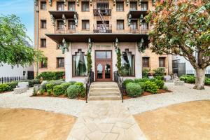 a brick building with a staircase leading to the front door at The Nirvana Apartment Hotel in Los Angeles