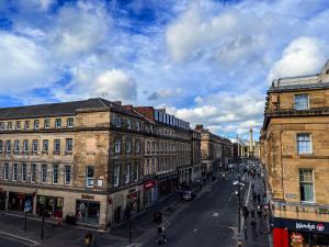 a city street with buildings and people walking on the street at 3 Bedroom Apartment in the Heart of Newcastle - Modern - Sleeps 6 in Newcastle upon Tyne