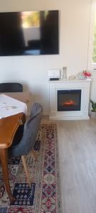 a living room with a table and a fireplace at Bila Lumbrela in Supetar