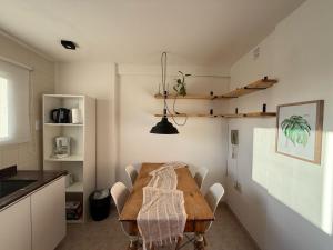 a kitchen with a wooden table and chairs in a room at Mirador del Puerto in Santa Fe