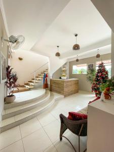 a living room with a christmas tree and stairs at Pousada do Grande Lago in Lindóia