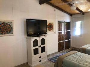 a living room with a tv on a wall at UMA Cabañas in Lozano