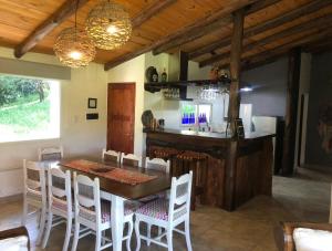 a dining room with a wooden table and chairs at UMA Cabañas in Lozano