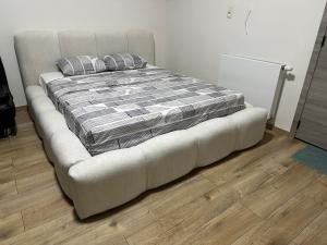 a bed in a room with a couch with pillows at Sweet apartment with belcon in Brussels