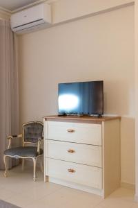 a bedroom with a dresser with a tv on it at Estúdio AMar - Always Algarve in Porches