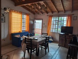 a living room with a table and chairs and a tv at Lo de Mary in Villa Elisa